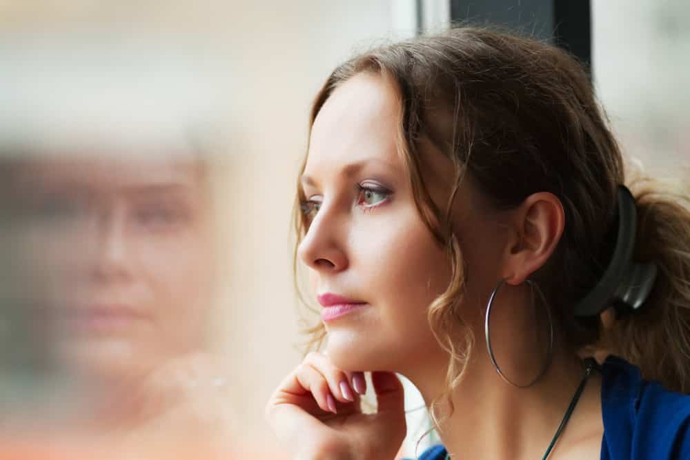 a woman staring out a window 