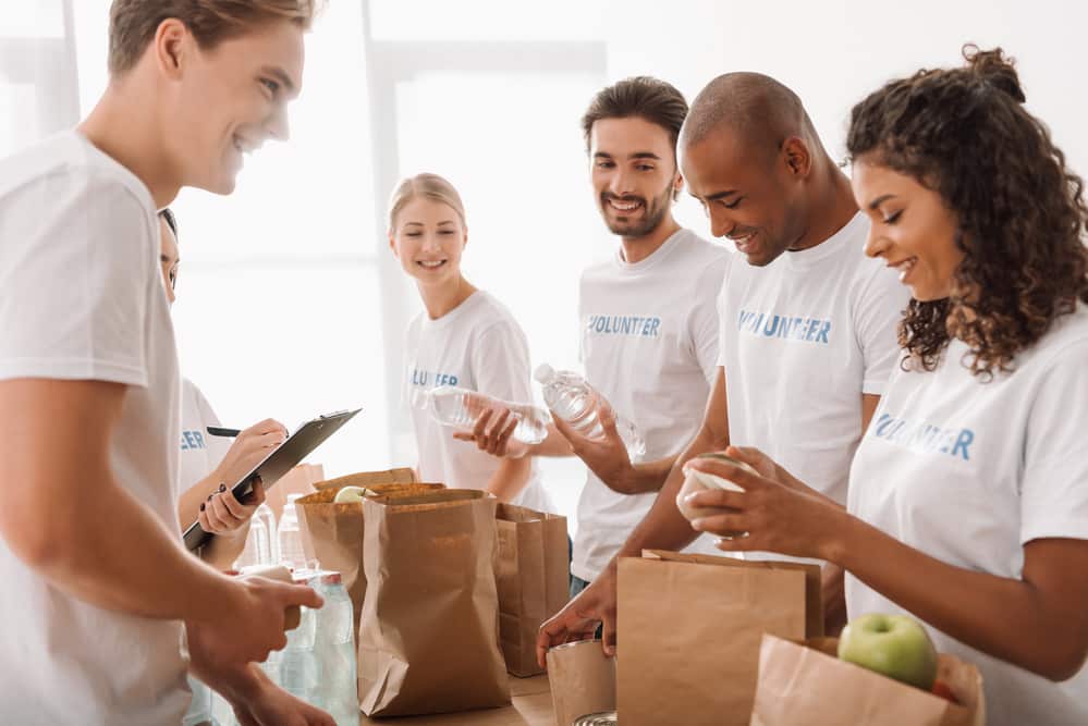 healthy people serving others by volunteering at a local food drive