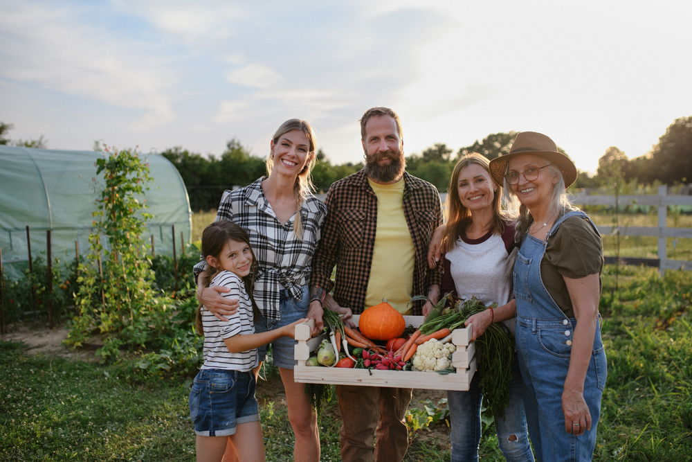 A family harvesting produce from their self-sufficient farm