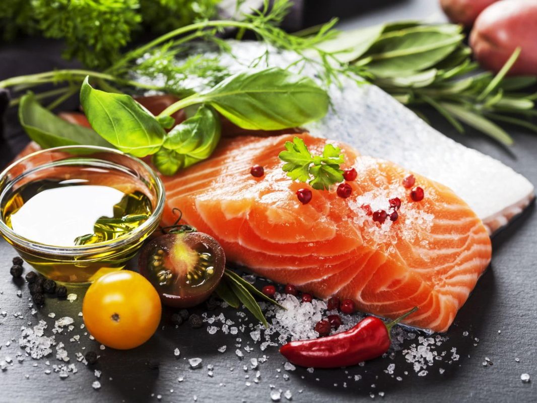 nutrient dense salmon , herbs, and tomatoes for a healthy diet